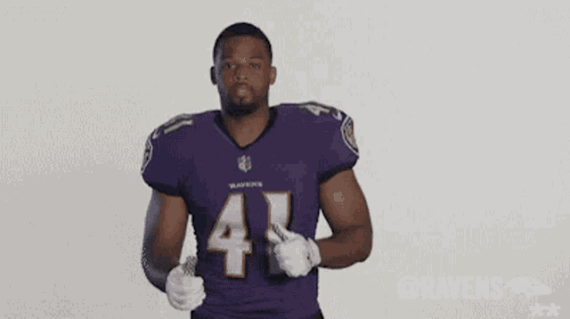 a ravens football player is giving a thumbs up .