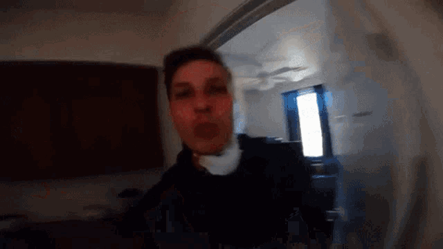 a blurry picture of a man standing in a room