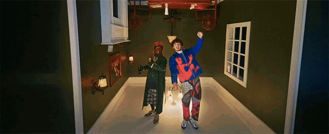 two people are dancing in a room with a sign on the wall that says ' a '