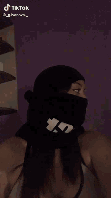 a woman wearing a black hat and headphones is giving a high five to someone .