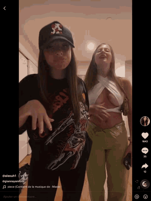 two women are standing next to each other with one wearing a shirt that says ' jesus ' on it