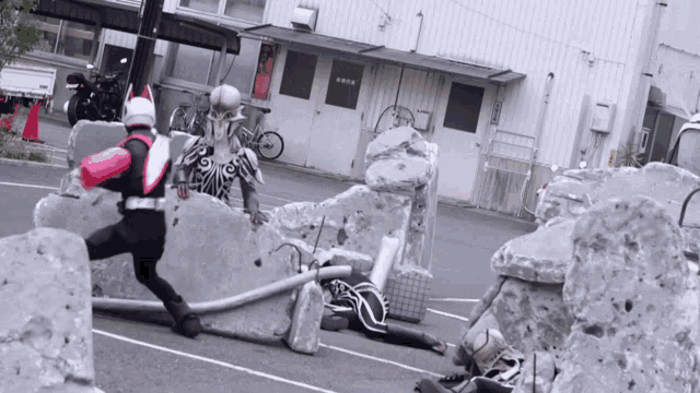 a man in a superhero costume is running across a concrete barrier