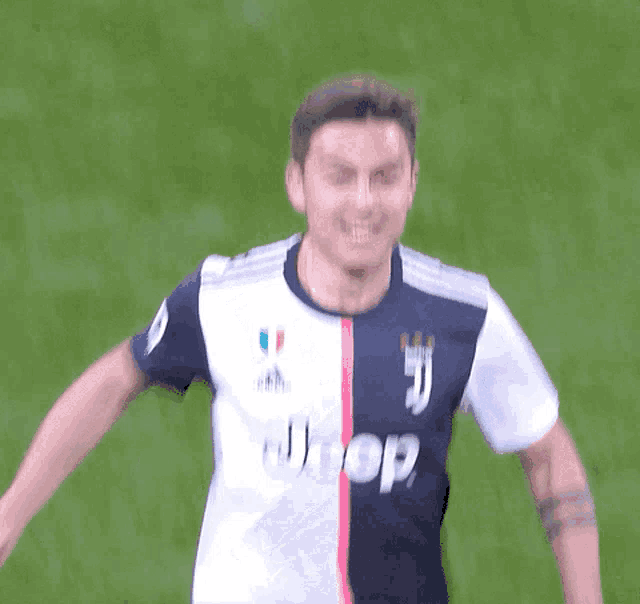 a man wearing a jeep jersey is smiling on a soccer field
