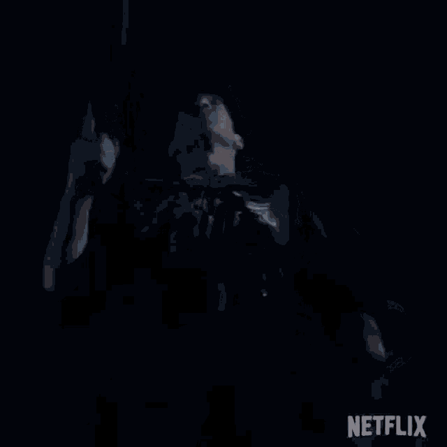 a man is holding a gun in a dark room with netflix written on the bottom