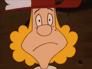 a cartoon character with blonde hair and a red hat making a sad face