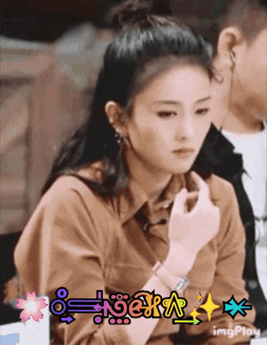 a woman 's face is shown in a gif with a watermark that says " imgplay "