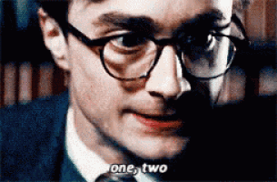 a close up of a man wearing glasses and a tie says one two