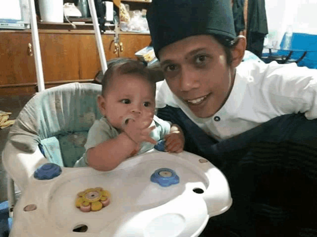 a man and a baby are posing for a picture together