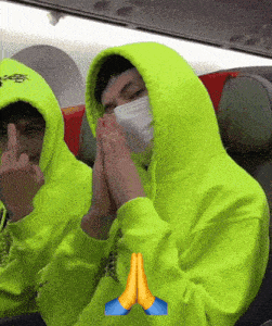 a man in a neon green hoodie with a face mask on his face