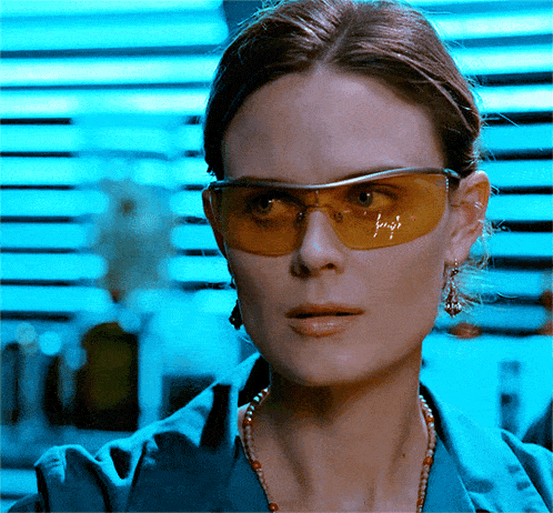 a close up of a woman wearing a pair of yellow safety goggles