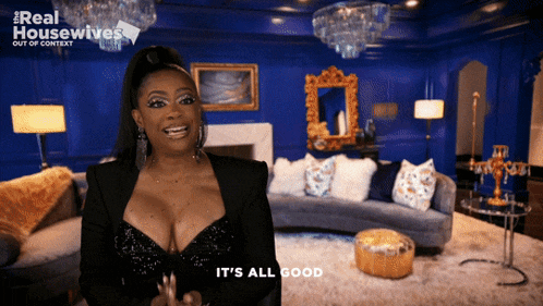 a woman says it 's all good in front of a blue room