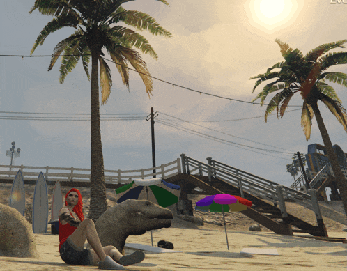 a woman sits on a beach next to a dinosaur and a colorful umbrella