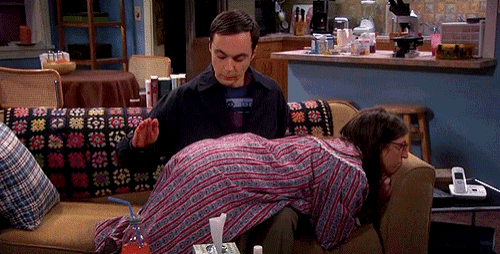 a man is spanking a woman on a couch in a living room