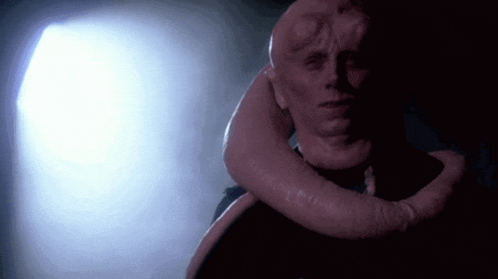 a close up of a man 's face with a long neck .