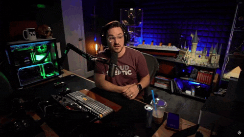 a man sitting in front of a microphone with the words or maybe they won 't