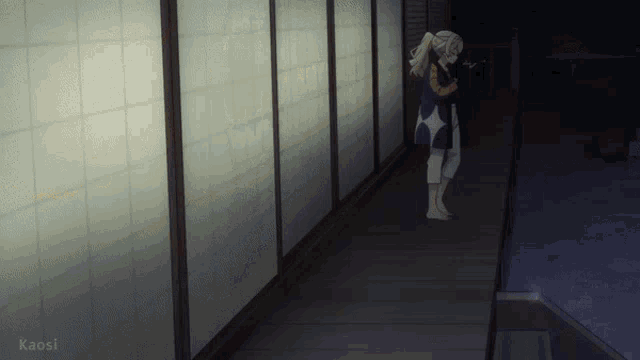 a woman stands in a hallway with kaosi written on the bottom