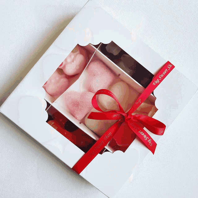 a white box with a red ribbon that says ' my sweet tea shop '
