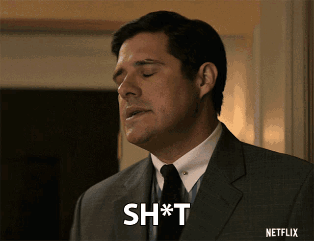 a man in a suit and tie says " sh * t "