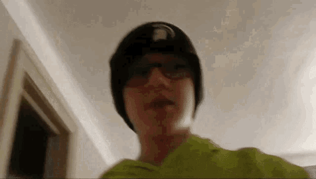 a blurry picture of a person wearing a hat and glasses