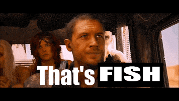 a man sitting in a car with the words that 's fish above him