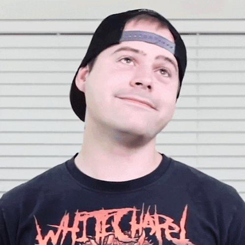 a man wearing a black shirt that says white chapel on it