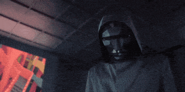 a man stands in a room with game over written on the wall
