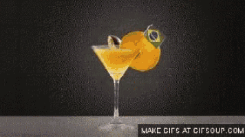 a martini glass with an orange slice and a brazilian flag on it