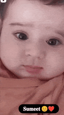a close up of a baby 's face with the name sumeeter on the bottom right