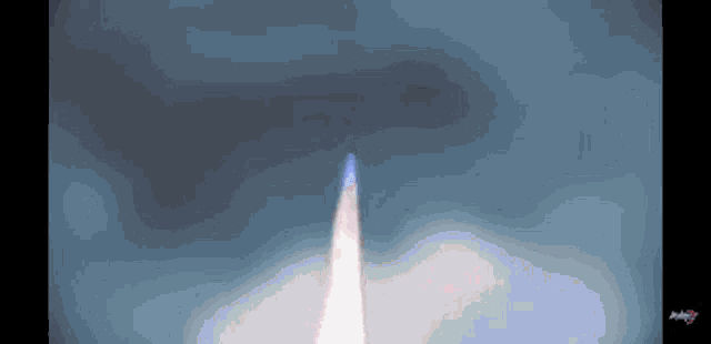 a computer generated image of a rocket flying through a cloudy sky .