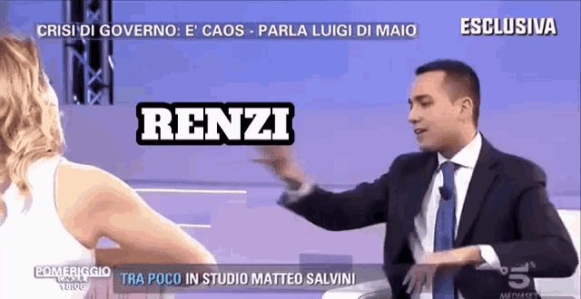 a man in a suit and tie is talking to a woman with the name renzi written on the screen