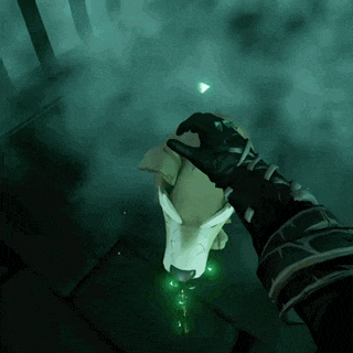 a person is holding a glowing object in a dark room .