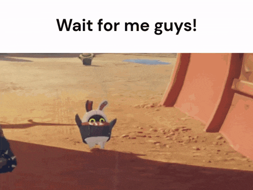 a penguin in a bunny costume is standing on a sandy beach .
