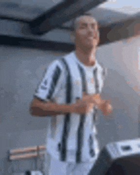 a man in a striped shirt is running in a room .