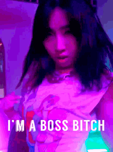a woman in a purple shirt with the words " i 'm a boss bitch "