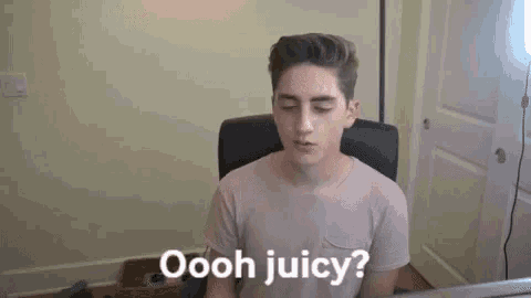 a young man is sitting at a desk in front of a computer and says `` ooh juicy '' .