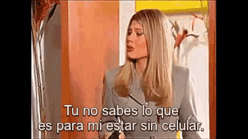 a woman is talking to another woman in spanish while holding a pen .