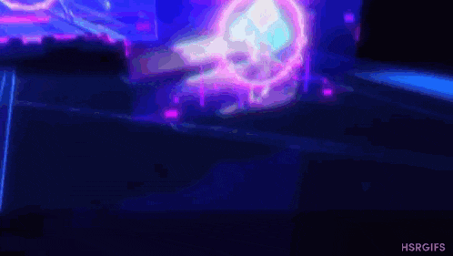 a person is standing in front of a computer screen with a purple and blue light coming out of it .