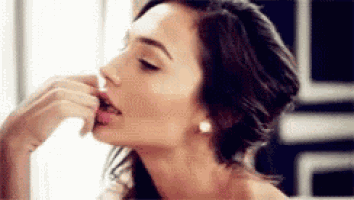 a close up of a woman 's face with her tongue out .