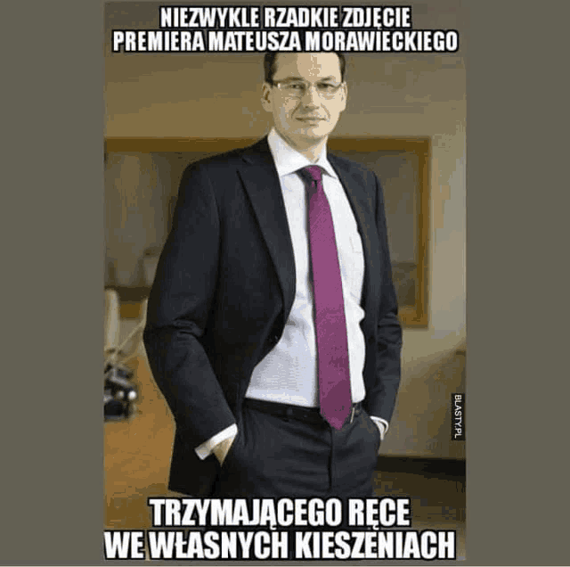 a man in a suit and tie is standing with his hands in his pockets and the caption says niezwykle