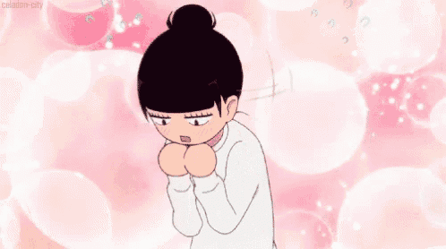 a cartoon girl with a bun is standing with her hands on her face .