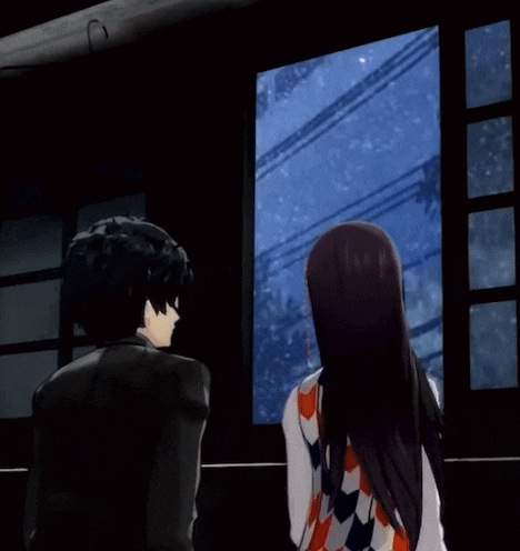 a man and a woman are hugging and looking out a window