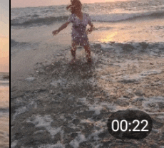 a girl is splashing in the ocean with a clock showing the time of 20:22