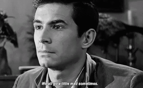 a black and white photo of a man sitting in a chair with the words `` we all go a little mad sometimes '' .