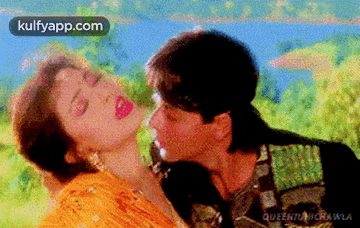 a man is kissing a woman on the cheek in a movie .