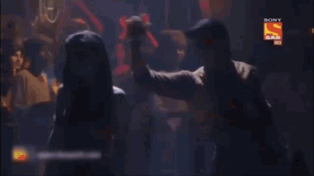 a man and a woman are dancing in a room with a sony logo in the corner