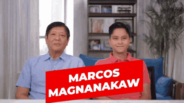two men sitting next to each other with a red sign that says marcos magnanakaw