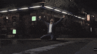 a man in a suit is dancing in front of a sign that says ' mama '