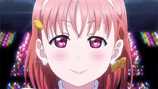 a close up of a girl with pink hair and red eyes wearing a headband and earrings .