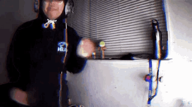 a man wearing headphones and a hoodie that says ' fila ' on the front