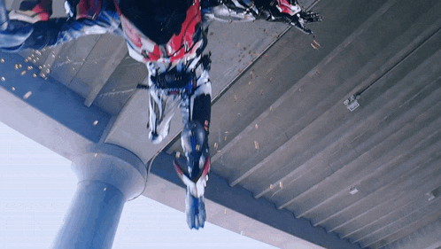 a person in a robot costume is falling from the ceiling